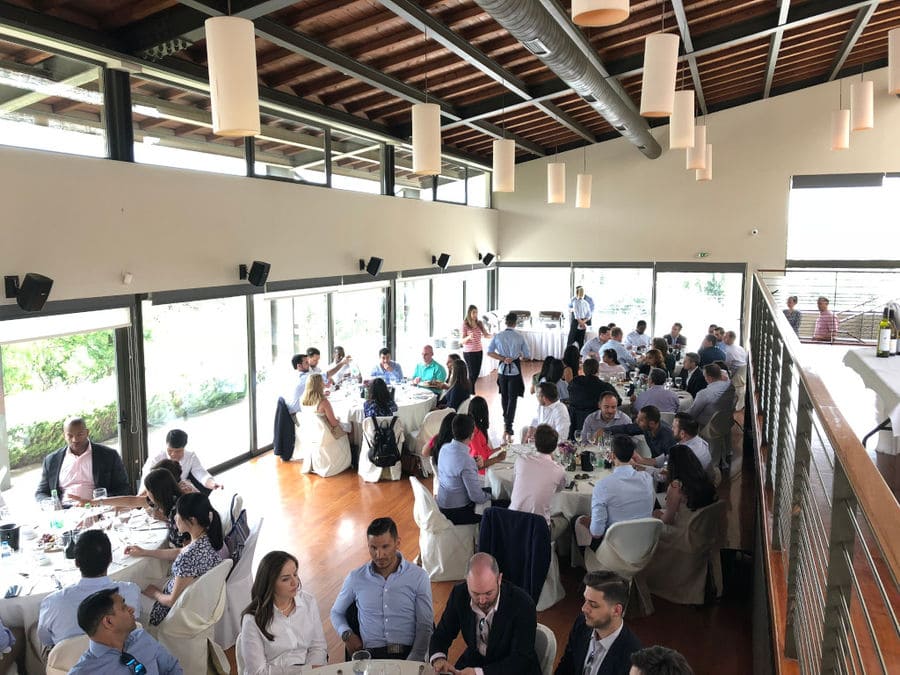 view from above of tourists drinking wines at Domaine Papagiannakos tasting room